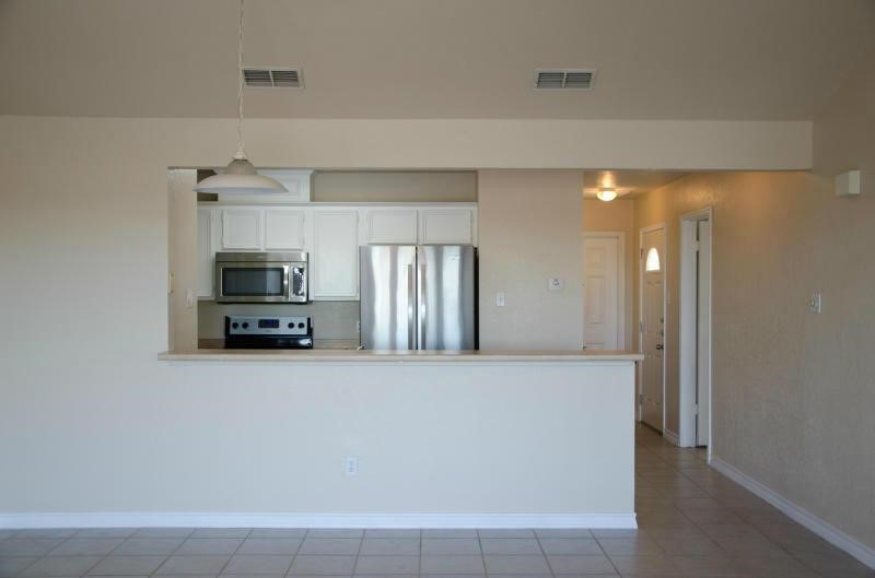 14302 Cruiser Street, Unit A Corpus Christi, TX 78418 - Photo 13 of 28 a view of kitchen with stainless steel appliances a refrigerator and a stove
