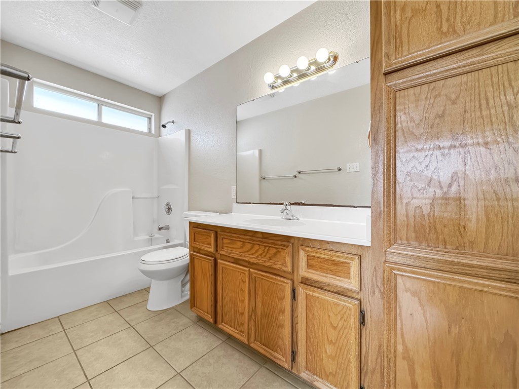 14302 Cruiser Street, Unit A Corpus Christi, TX 78418 - Photo 16 of 28 a bathroom with a sink a toilet and shower