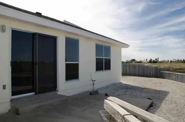 a swimming pool with outdoor seating and yard