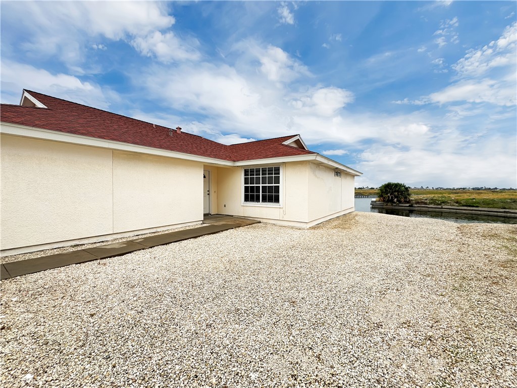 14302 Cruiser Street, Unit A Corpus Christi, TX 78418 - Photo 2 of 28 a view of house with backyard and bushes