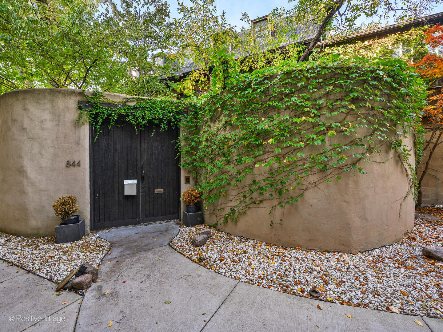 a backyard of a house with a tree