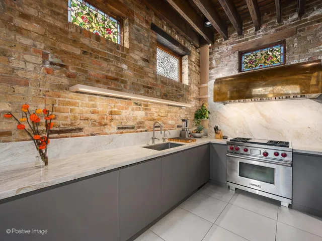 a kitchen with stainless steel appliances granite countertop a sink and a stove