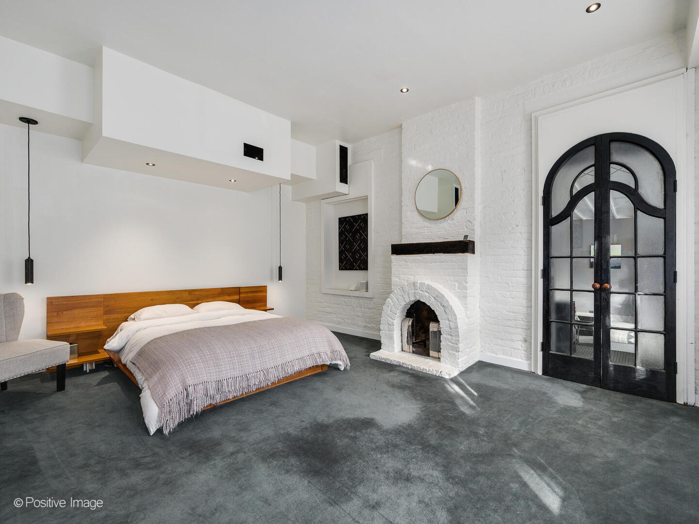 844 West Altgeld Street Chicago, IL 60614 - Photo 18 of 27 a spacious bedroom with a bed and a fireplace