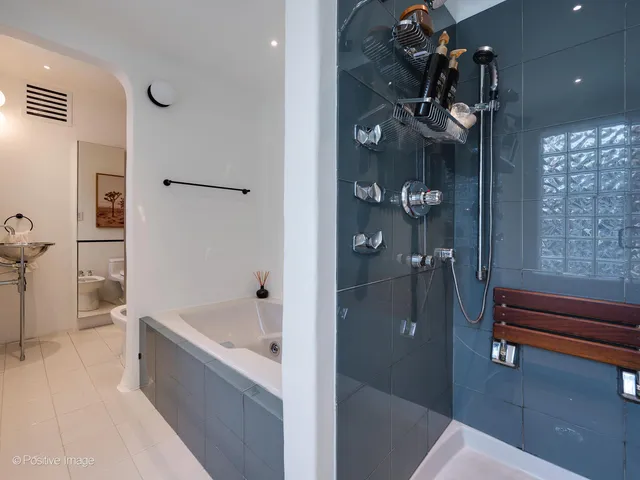a bathroom with a bathtub and a shower