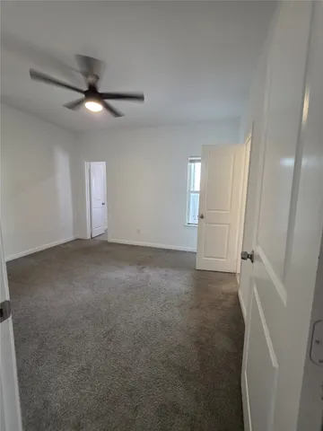 an empty room with closet and windows