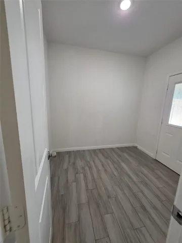 a view of an empty room and wooden floor