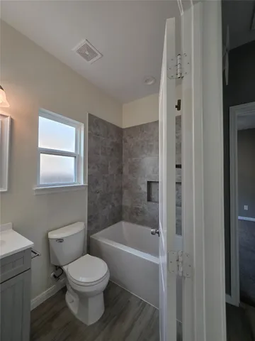 a bathroom with a toilet and a bathtub