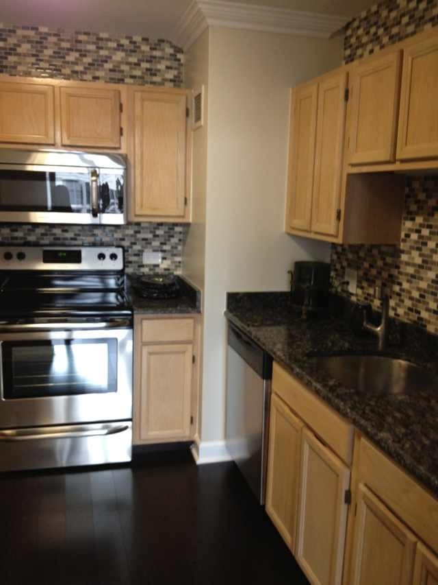 200 North Dearborn Street, Unit 2703 Chicago, IL 60601 - Photo 13 of 16 a kitchen with stainless steel appliances granite countertop a stove and a microwave