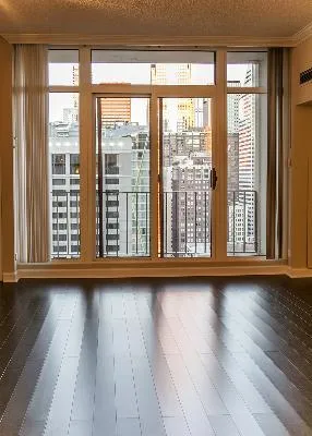 a view of a room with wooden floor and door