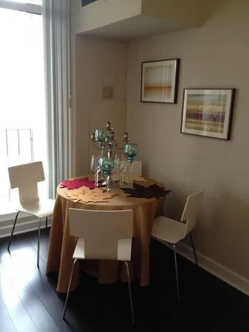 a dining room with furniture and wooden floor