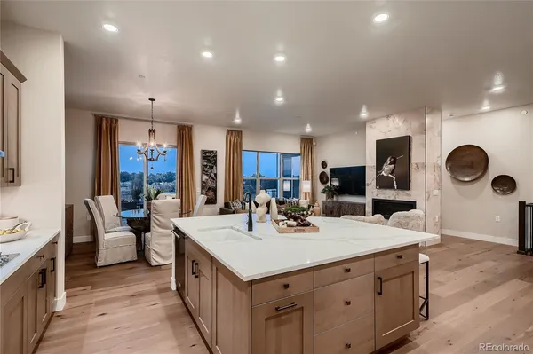 a large kitchen with kitchen island a large counter top stainless steel appliances and cabinets