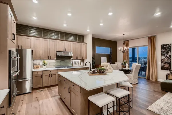 a large kitchen with a table and chairs
