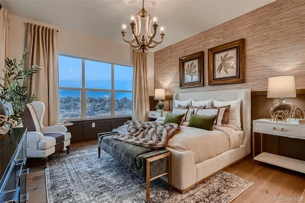 a bedroom with a bed and a chandelier