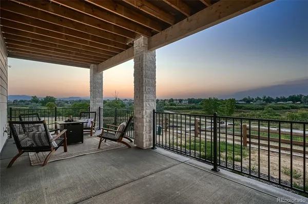 a view of a terrace with couches and city view
