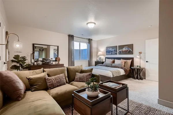 a living room with furniture kitchen view and a chandelier