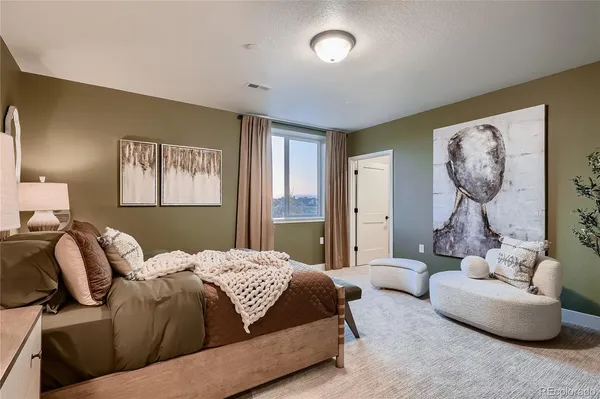 a bedroom with a bed and couch