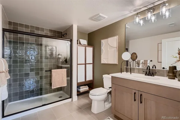 a kitchen with granite countertop a stove a sink a counter top space and cabinets