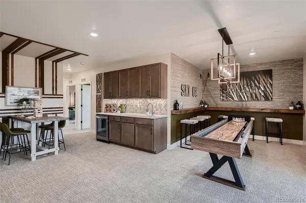 a kitchen with a table chairs sink and cabinets