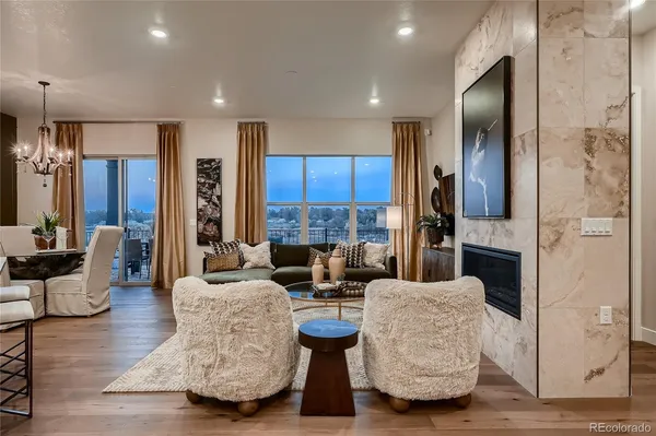 a living room with fireplace furniture and a flat screen tv