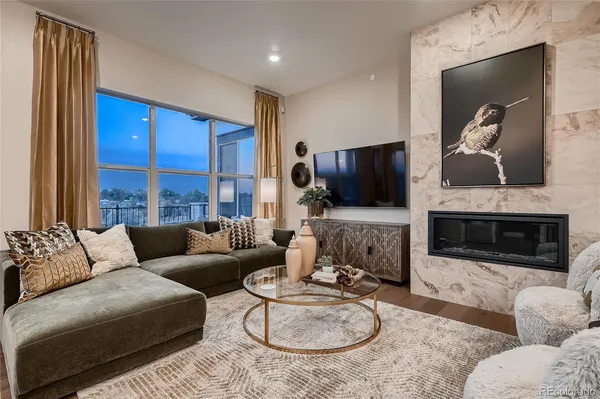 a living room with fireplace furniture and a flat screen tv
