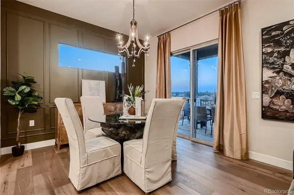a dining room with furniture and wooden floor