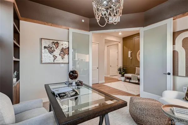 a living room with furniture and a chandelier