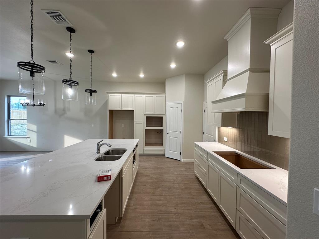 130 Lasso Loop Lorena, TX 76655 - Photo 3 of 14 a kitchen with granite countertop a sink and a stove top oven