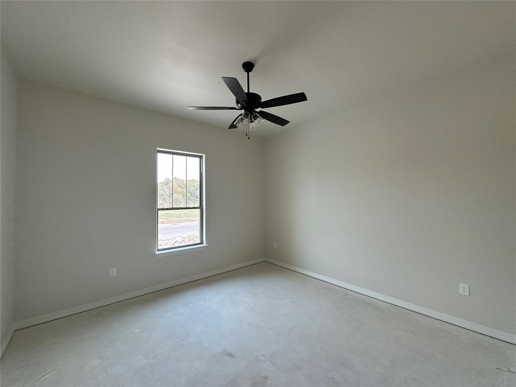 130 Lasso Loop Lorena, TX 76655 - Photo 5 of 14 an empty room with a window and a ceiling fan