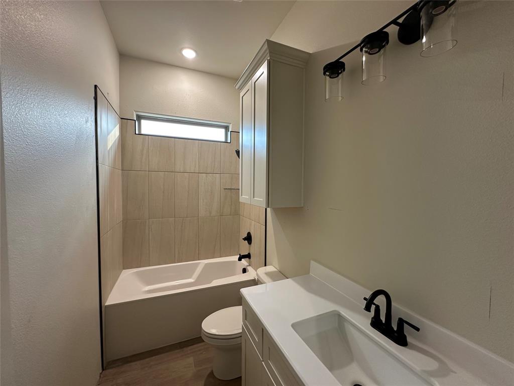 130 Lasso Loop Lorena, TX 76655 - Photo 6 of 14 a bathroom with a bathtub shower sink vanity and toilet