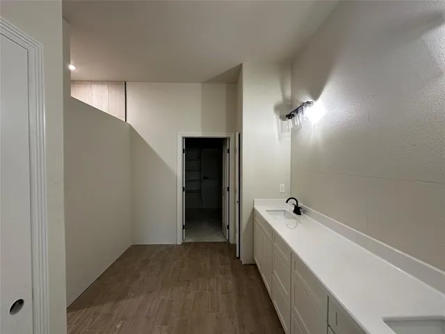 a bathroom with a double vanity sink and mirror with shower