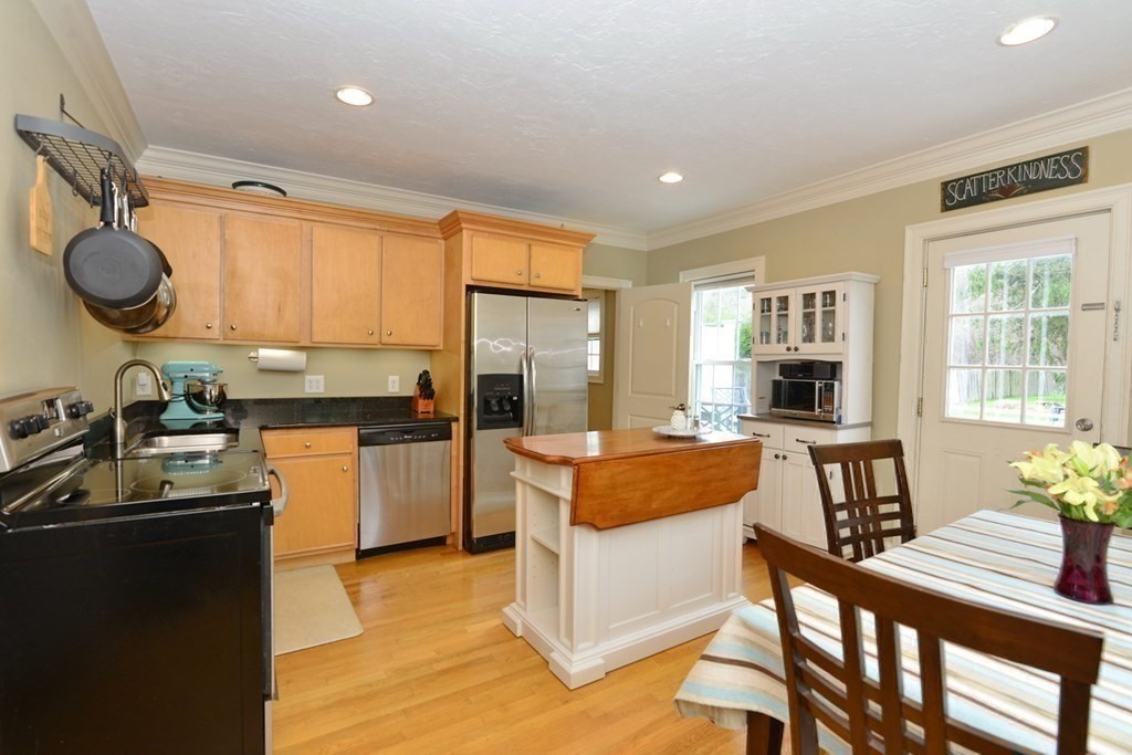 9 Ray Avenue Bellingham, MA 02019 - Photo 14 of 32 a kitchen with a stove a refrigerator and a dining table