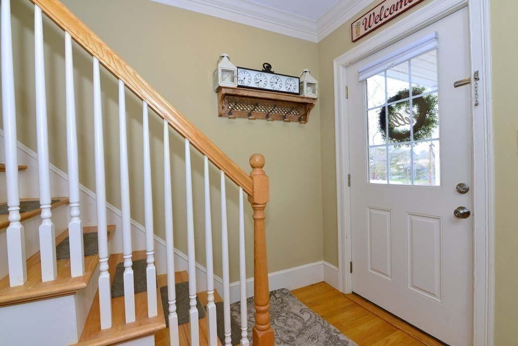 9 Ray Avenue Bellingham, MA 02019 - Photo 15 of 32 a view of a hallway with wooden floor and staircase