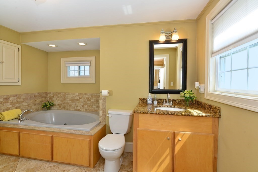 9 Ray Avenue Bellingham, MA 02019 - Photo 19 of 32 a bathroom with a granite countertop sink and a mirror