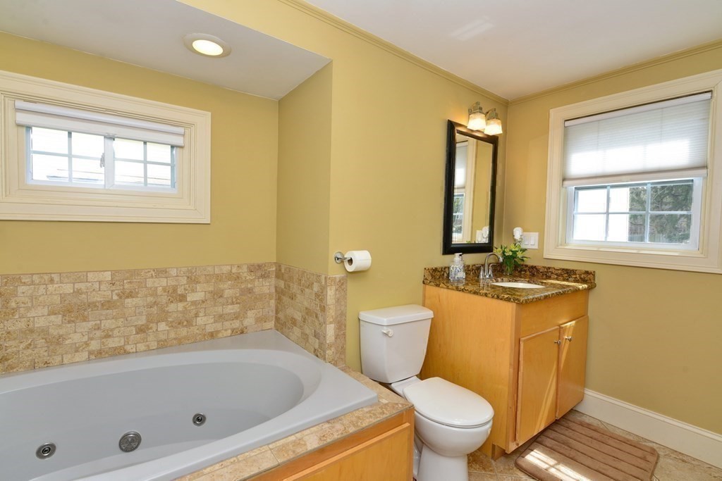 9 Ray Avenue Bellingham, MA 02019 - Photo 20 of 32 a bathroom with a granite countertop toilet a sink and a bathtub