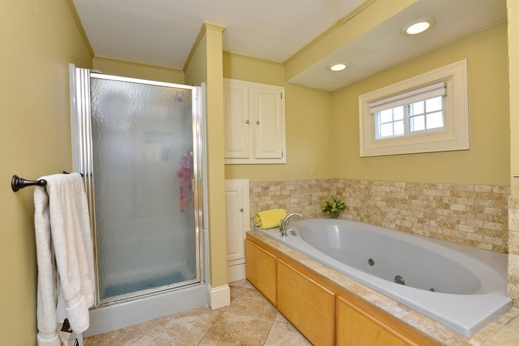 9 Ray Avenue Bellingham, MA 02019 - Photo 21 of 32 a bathroom with a bathtub and a shower
