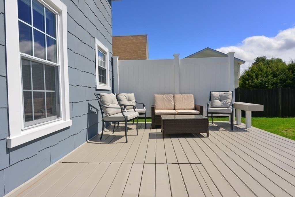9 Ray Avenue Bellingham, MA 02019 - Photo 23 of 32 a roof deck with table and chairs and wooden floor