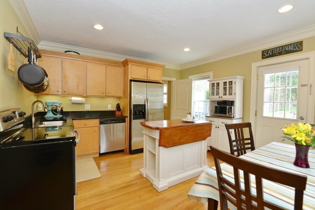 9 Ray Avenue Bellingham, MA 02019 - Photo 8 of 32 a kitchen with a table chairs refrigerator and cabinets