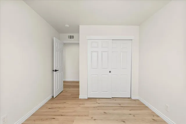 a view of a balcony with wooden floor and fence