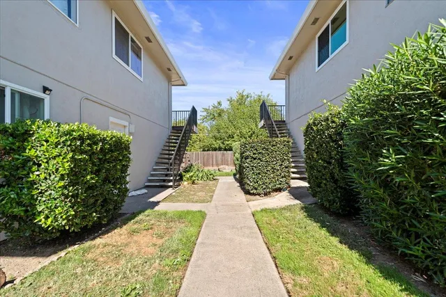 a view of a street with a house in the background