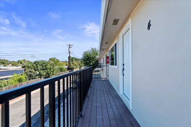 a view of a balcony with wooden floor