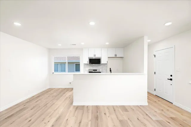 a view of kitchen with wooden floor and window