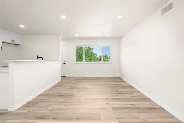 a kitchen with stainless steel appliances kitchen island a white stove top oven and sink
