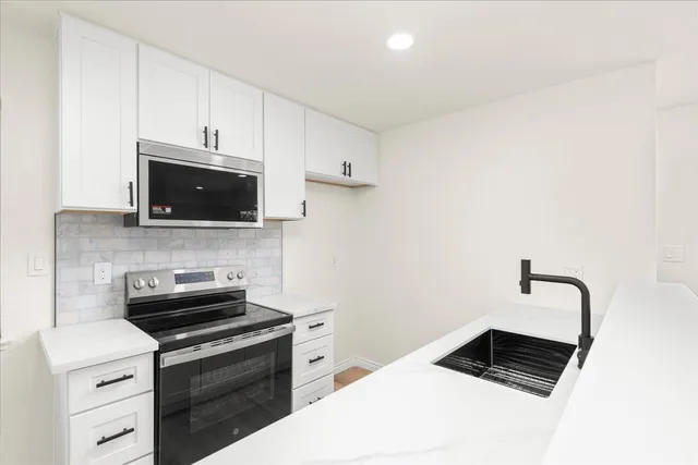 a kitchen with a sink and a refrigerator