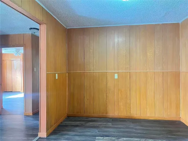 a view of a room with wooden floor and cabinet