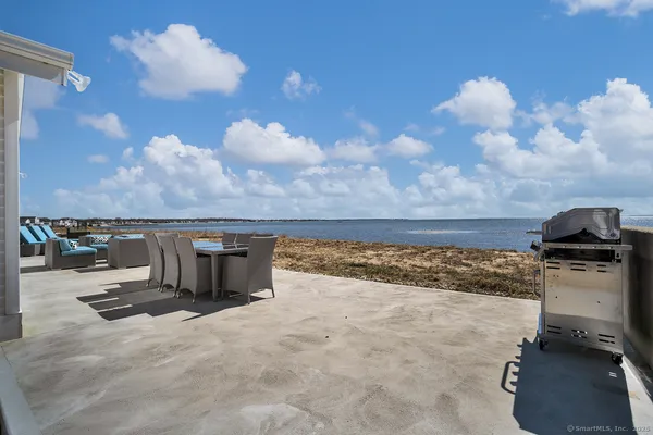 a roof deck with table and chairs