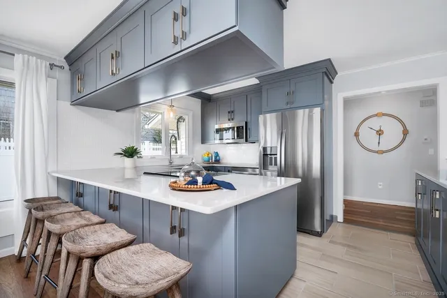 a kitchen with refrigerator and cabinets