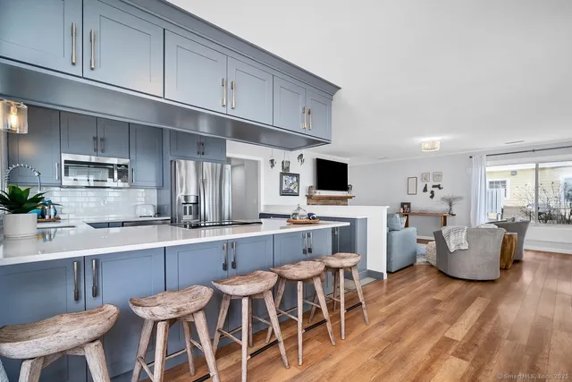 a kitchen with stainless steel appliances kitchen island granite countertop a sink and cabinets