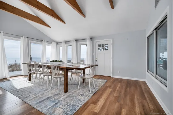 a view of a dining room with furniture and wooden floor