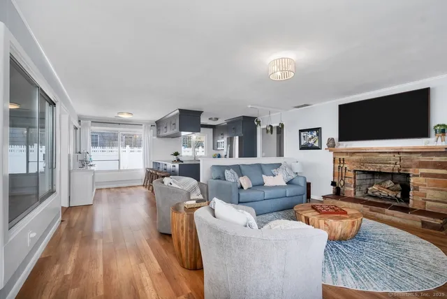 a living room with fireplace furniture and a flat screen tv