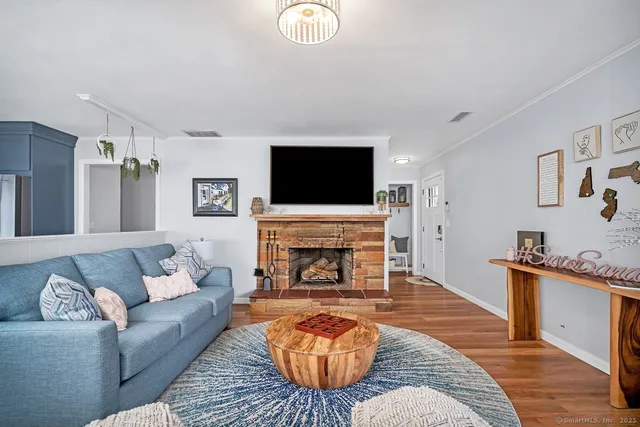 a living room with furniture a fireplace and a flat screen tv